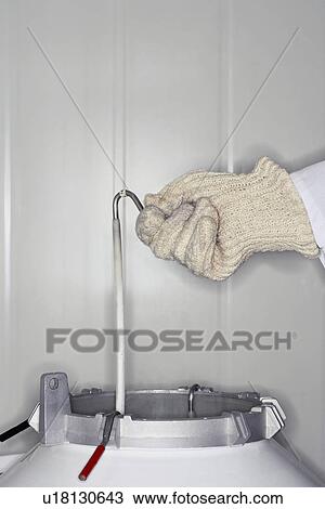 Person holding rack in nitrogen tank close up View Large Photo Image Stock Image - Person holding rack in nitrogen tank close up. Fotosearch