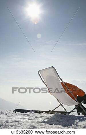 Person sitting in lawn chair in snow View Large Photo Image Stock Image - Person sitting in lawn chair in snow. Fotosearch
