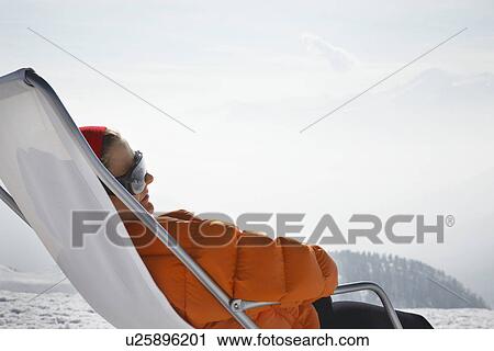 Person sitting in lawn chair in snow View Large Photo Image Stock Image - Person sitting in lawn chair in snow. Fotosearch