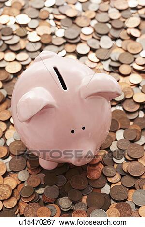 Stock Photo - Piggy bank and vast amount of coins. Fotosearch