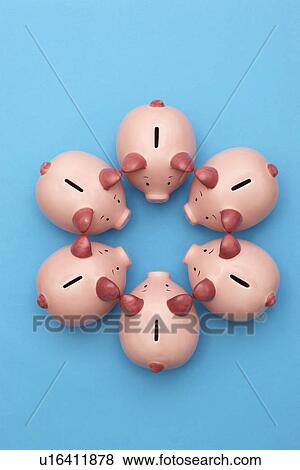 Stock Photo - Piggy banks on blue background view from above. Fotosearch