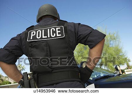 Police officer in bulletproof vest outdoors back view View Large Photo Image Stock Photograph - Police officer in bulletproof vest outdoors back view. Fotosearch