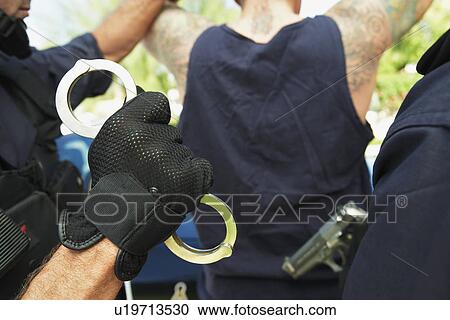 Police officers in action close-up of handcuffs View Large Photo Image Stock Image - Police officers in action close-up of handcuffs. Fotosearch
