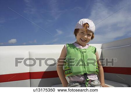 Portrait of boy (7-9) in life jacket View Large Photo Image Stock Image - Portrait of boy (7-9) in life jacket. Fotosearch