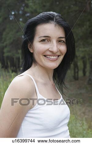 Portrait of mid-adult woman near forest View Large Photo Image Picture - Portrait of mid-adult woman near forest. Fotosearch