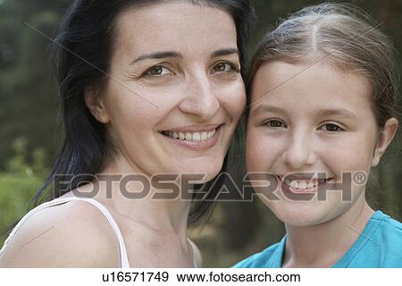 Portrait of mother and daughter close-up View Large Photo Image Stock Photo - Portrait of mother and daughter close-up. Fotosearch
