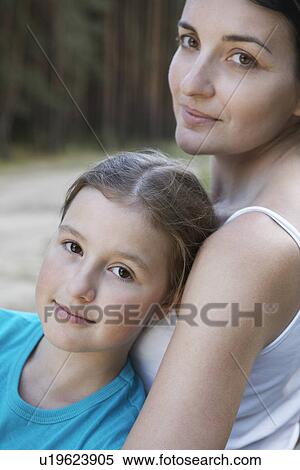 Stock Photography - Portrait of mother and daughter relaxing close-up. Fotosearch