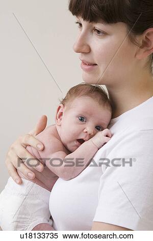 Portrait of mother hugging her newborn baby studio shot View Large Photo Image Stock Photography - Portrait of mother hugging her newborn baby studio shot. Fotosearch
