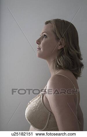 Stock Image - Portrait of semi-dress mid adult woman. Fotosearch
