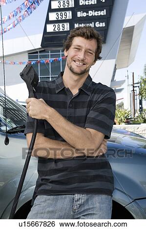 Portrait of smiling man at natural gas station View Large Photo Image Stock Photograph - Portrait of smiling man at natural gas station. Fotosearch