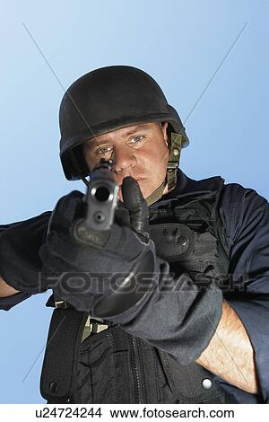 Portrait of Swat officer aiming gun View Large Photo Image Picture - Portrait of Swat officer aiming gun. Fotosearch