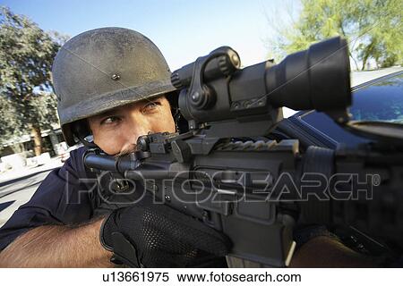 Portrait of Swat officer aiming gun View Large Photo Image Stock Photography - Portrait of Swat officer aiming gun. Fotosearch
