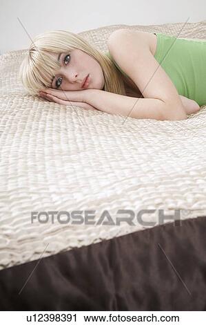 Portrait of teenage girl (16-17) lying on bed View Large Photo Image Stock Image - Portrait of teenage girl (16-17) lying on bed. Fotosearch