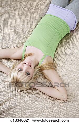 Portrait of teenage girl (16-17) lying on bed View Large Photo Image Stock Image - Portrait of teenage girl (16-17) lying on bed. Fotosearch