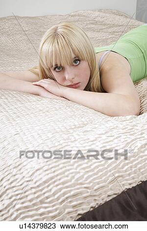 Portrait of teenage girl (16-17) lying on bed View Large Photo Image Stock Image - Portrait of teenage girl (16-17) lying on bed. Fotosearch