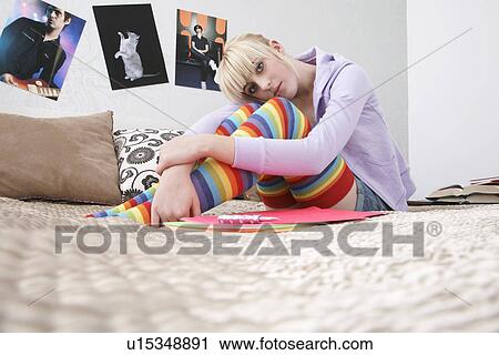 Portrait of teenage girl (16-17) sitting on bed View Large Photo Image Stock Image - Portrait of teenage girl (16-17) sitting on bed. Fotosearch