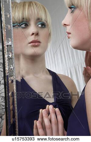 Portrait of teenage girl (16-17) looking in mirror View Large Photo Image Stock Image - Portrait of teenage girl (16-17) looking in mirror. Fotosearch
