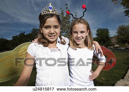 Portrait of two girls (7-12) wearing costumes View Large Photo Image Stock Photo - Portrait of two girls (7-12) wearing costumes. Fotosearch