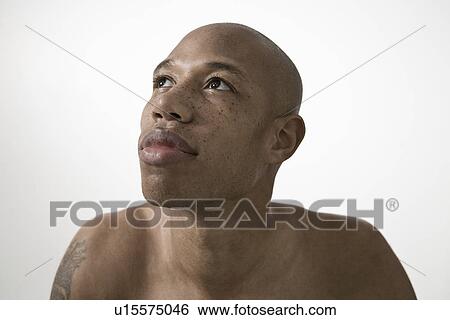 Stock Photograph - Portrait of young man head and shoulders. Fotosearch