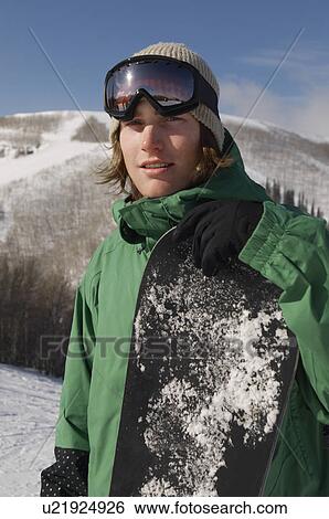 Portrait of young snowboarder smiling View Large Photo Image Stock Photograph - Portrait of young snowboarder smiling. Fotosearch