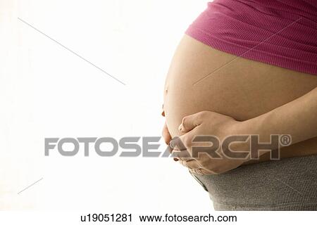 Pregnant woman mid section View Large Photo Image Stock Image - Pregnant woman mid section. Fotosearch
