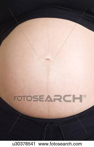 Pregnant woman mid section View Large Photo Image Stock Image - Pregnant woman mid section. Fotosearch