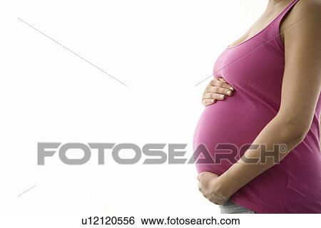 Stock Photograph - Pregnant woman mid section. Fotosearch