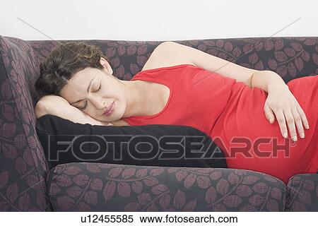Pregnant woman sleeping on sofa View Large Photo Image Stock Photography - Pregnant woman sleeping on sofa. Fotosearch