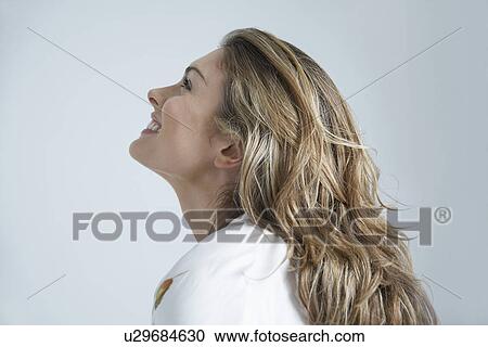 Profile of young woman smiling View Large Photo Image Stock Image - Profile of young woman smiling. Fotosearch