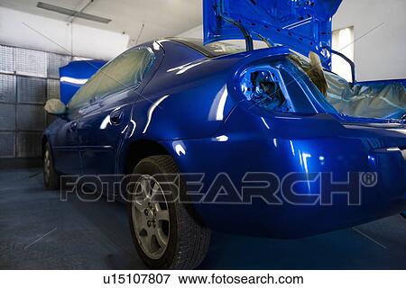 Stock Photo - Rear of blue painted car in garage. Fotosearch