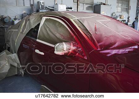 Stock Image - Red painted car in garage. Fotosearch