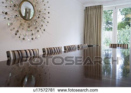 Stock Image - Reflection on table top in dining room. Fotosearch