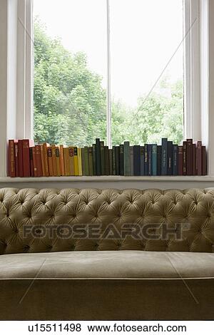 Row of books on windowsill View Large Photo Image Stock Photo - Row of books on windowsill. Fotosearch