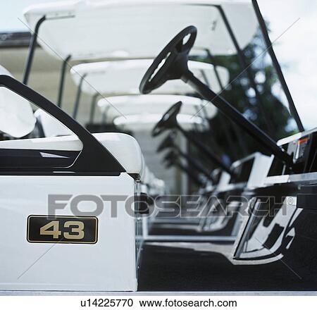 Stock Image - Row of golf carts. Fotosearch