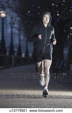 Stock Image - Runner training on early winter morning in London. Fotosearch