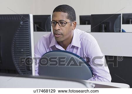 Serious African American Businessman Working on Computer View Large Photo Image Stock Photo - Serious African American Businessman Working on Computer. Fotosearch