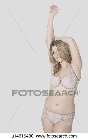 Stock Image - Sexy young woman in her underwear stretching. Fotosearch