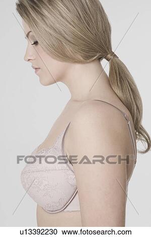 Stock Image - Sexy young woman wearing bra profile. Fotosearch