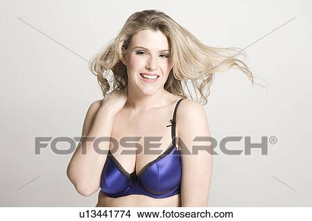 Sexy young woman wearing bra smiling View Large Photo Image Picture - Sexy young woman wearing bra smiling. Fotosearch