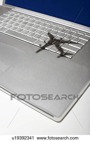 Shadow of jumbo jet over apple macintosh keyboard View Large Photo Image Stock Image - Shadow of jumbo jet over apple macintosh keyboard. Fotosearch