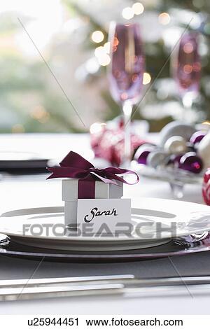 Small gift box with name tag on dining table View Large Photo Image Stock Image - Small gift box with name tag on dining table. Fotosearch
