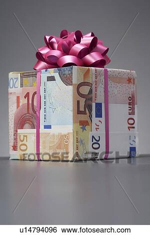Small gift wrapped in Euro notes with bow View Large Photo Image Stock Photograph - Small gift wrapped in Euro notes with bow. Fotosearch