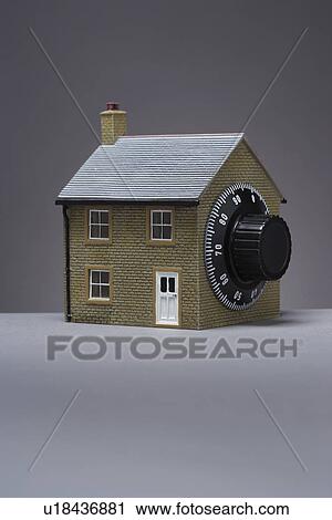 Stock Image - Small model of house with combination lock. Fotosearch