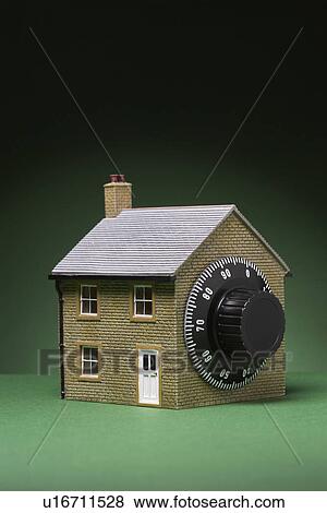 Stock Photo - Small model of house with combination lock. Fotosearch