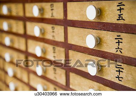 Stock Photograph - Small Wood Drawers With White Handles. Fotosearch