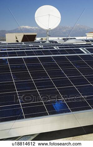 Stock Image - Solar Panels and Satellite Dish at Solar Power Plant. Fotosearch