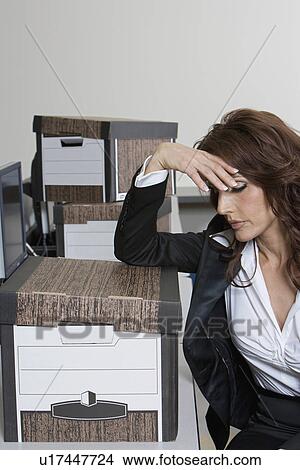 Picture - Stressed Businesswoman and Moving Boxes. Fotosearch