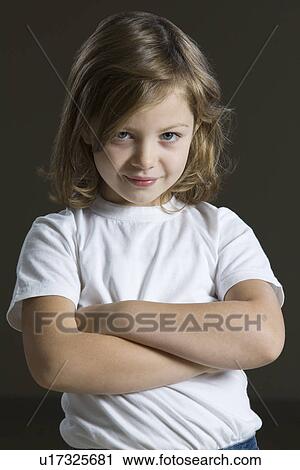 Stock Image - Studio portrait of girl with arms crossed. Fotosearch
