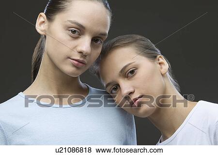 Studio portrait of two sisters View Large Photo Image Stock Photo - Studio portrait of two sisters. Fotosearch