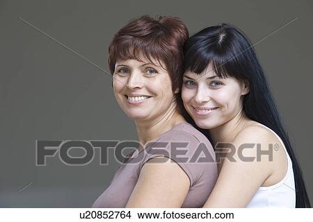 Picture - Studio portrait of young woman embracing mother. Fotosearch